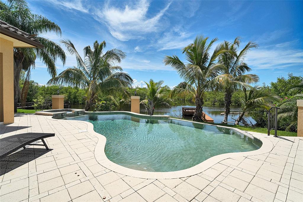 8707 Silverthorn Road Seminole, FL 33777 - Photo 2 of 58 a view of swimming pool with a garden and patio