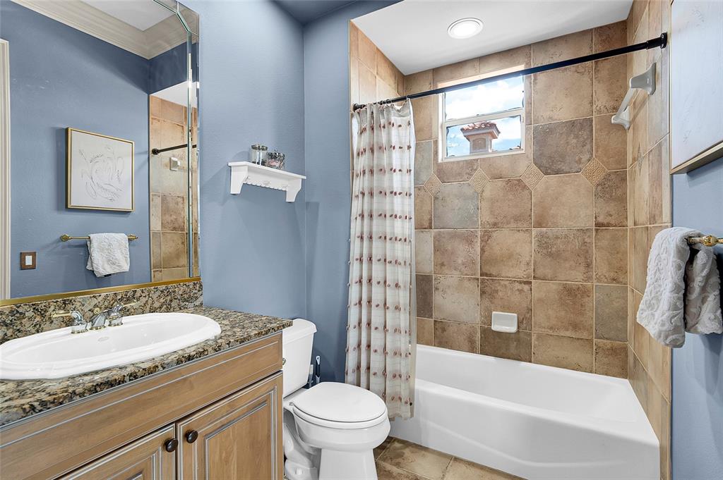 8707 Silverthorn Road Seminole, FL 33777 - Photo 30 of 58 a bathroom with a granite countertop sink toilet and shower