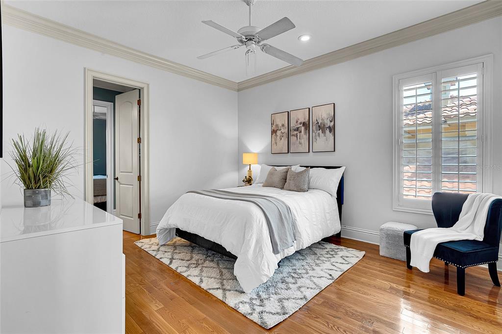 8707 Silverthorn Road Seminole, FL 33777 - Photo 31 of 58 a bedroom with a bed and wooden floor