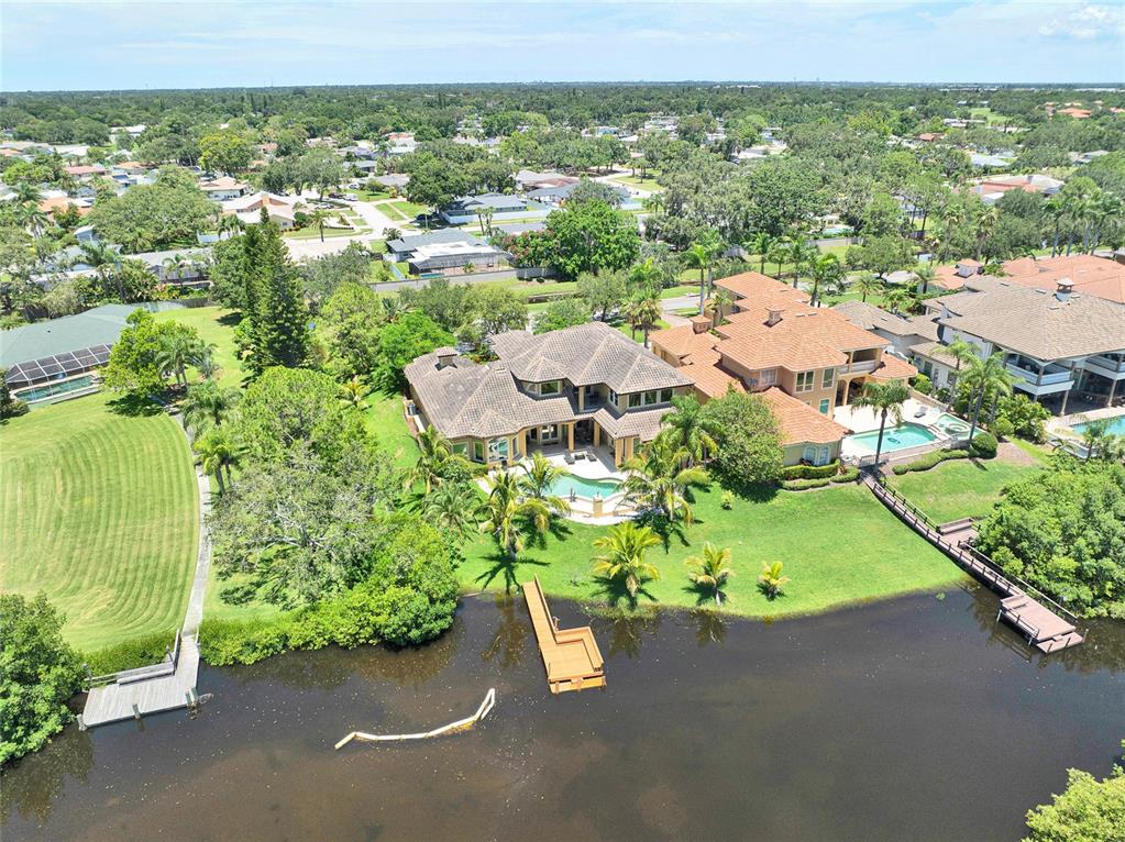 8707 Silverthorn Road Seminole, FL 33777 - Photo 41 of 58 an aerial view of a house with a yard and lake view