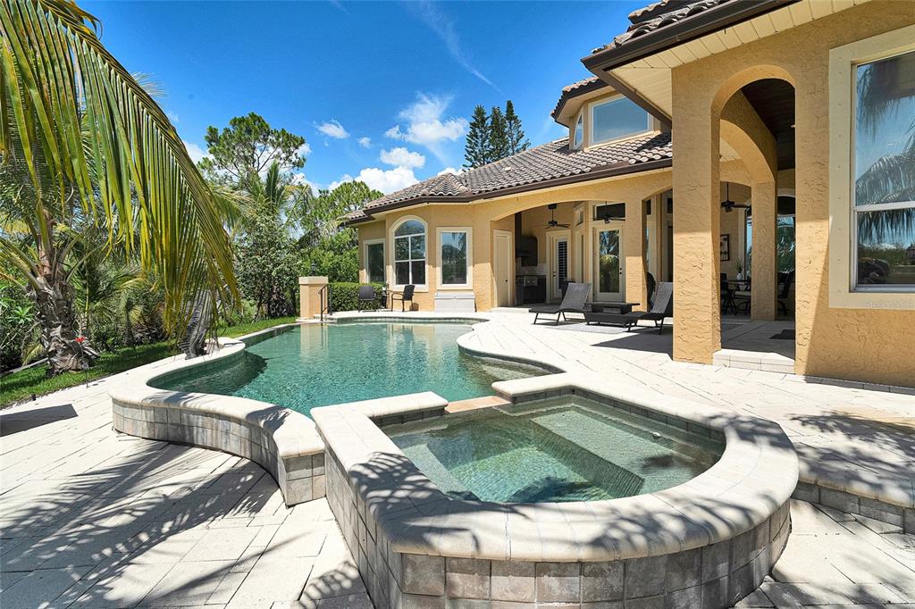 8707 Silverthorn Road Seminole, FL 33777 - Photo 43 of 58 a view of a house with swimming pool and sitting area