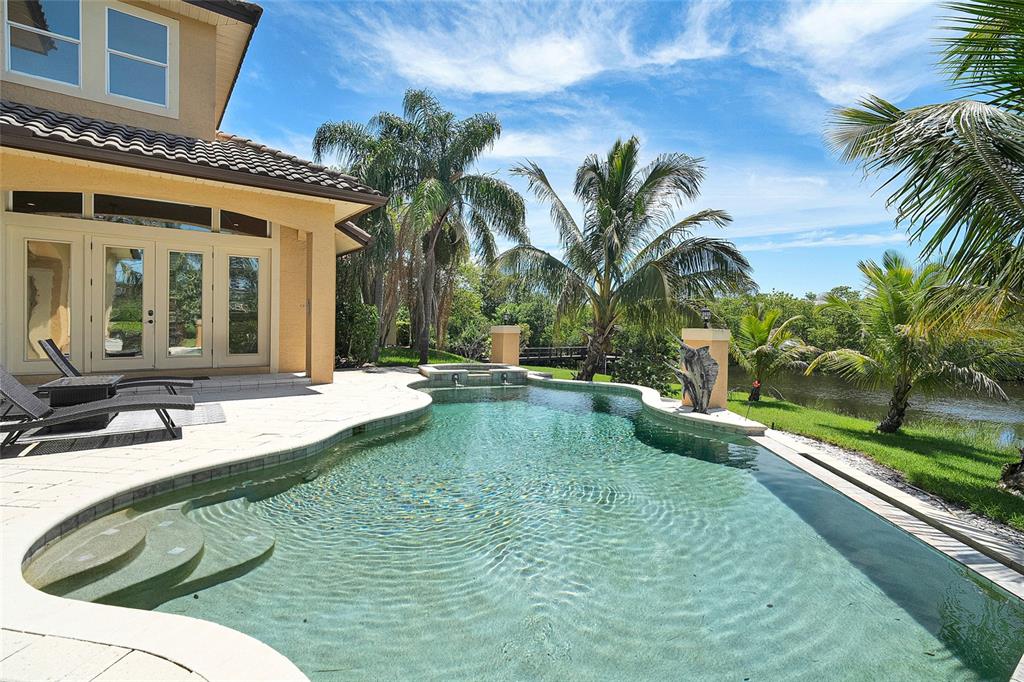 8707 Silverthorn Road Seminole, FL 33777 - Photo 44 of 58 a swimming pool with outdoor seating and yard