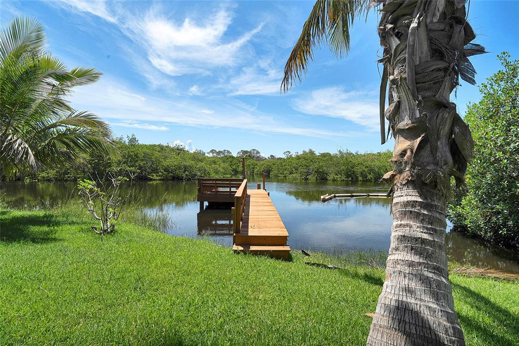 8707 Silverthorn Road Seminole, FL 33777 - Photo 47 of 58 a view of a lake with a yard
