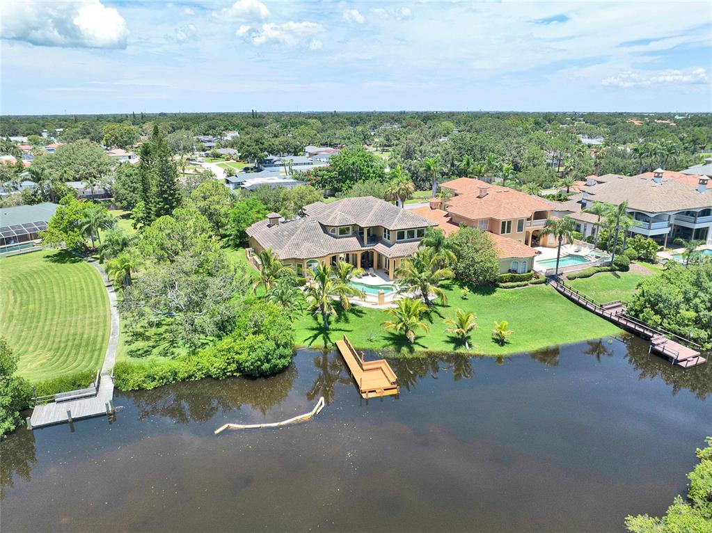8707 Silverthorn Road Seminole, FL 33777 - Photo 50 of 58 an aerial view of a house with a garden and lake view