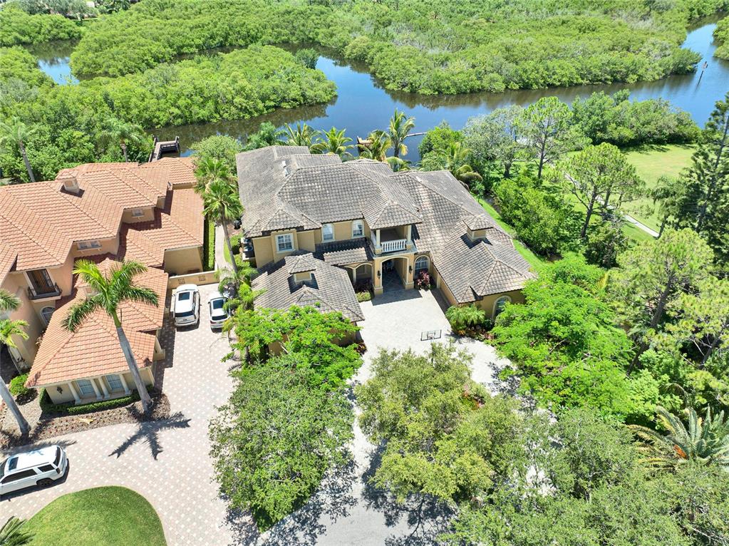 8707 Silverthorn Road Seminole, FL 33777 - Photo 52 of 58 an aerial view of a house with a garden and lake view