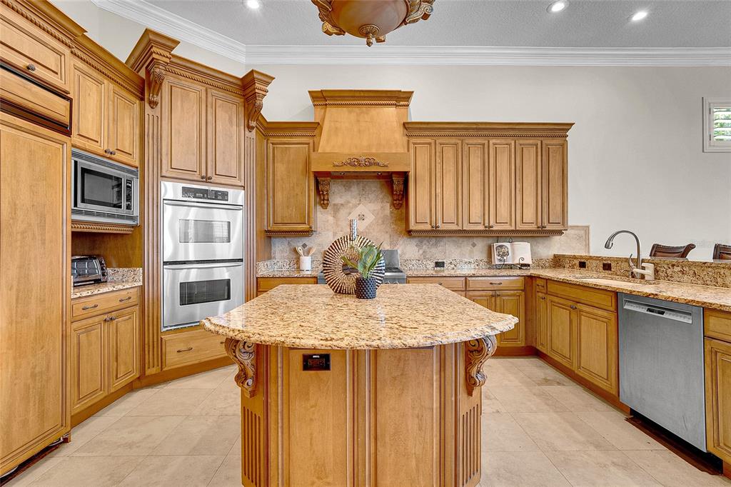 8707 Silverthorn Road Seminole, FL 33777 - Photo 7 of 58 a kitchen with stainless steel appliances granite countertop a sink dishwasher stove and refrigerator