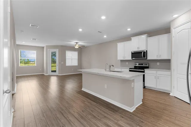 a kitchen with stainless steel appliances kitchen island wooden cabinets and granite counter tops