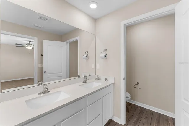 a bathroom with a shower sink and mirror