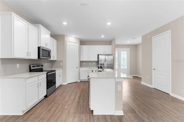 a view of a kitchen with electric appliances