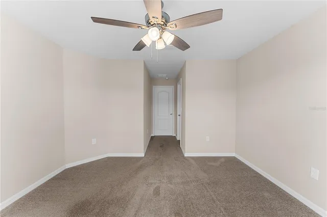 a kitchen with stainless steel appliances a white refrigerator cabinets and wooden floor