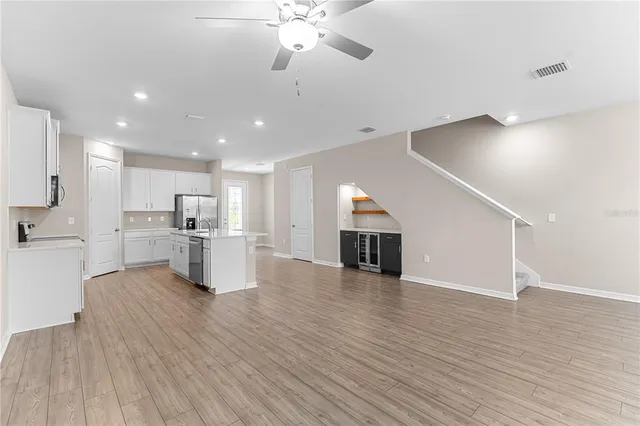 a view of kitchen with furniture and wooden floor