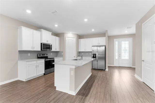 a view of kitchen with cabinets and wooden floor