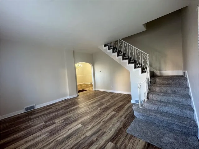 a view of a bedroom with wooden floor