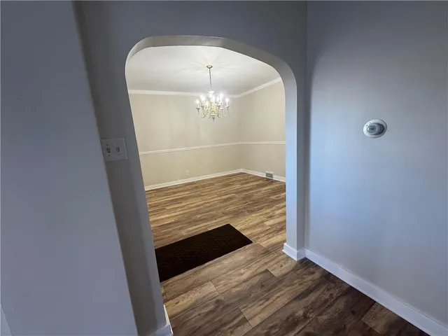a view of an empty room and wooden floor