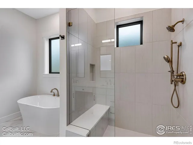 a bathroom with a bathtub and shower