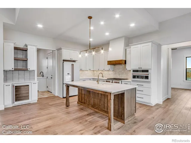 a kitchen with a stove a sink and a refrigerator