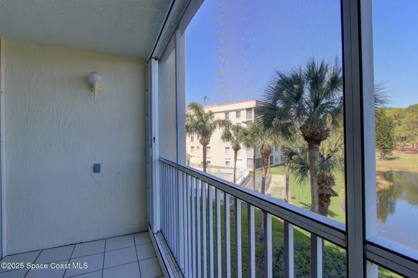 a view of a balcony with a tree