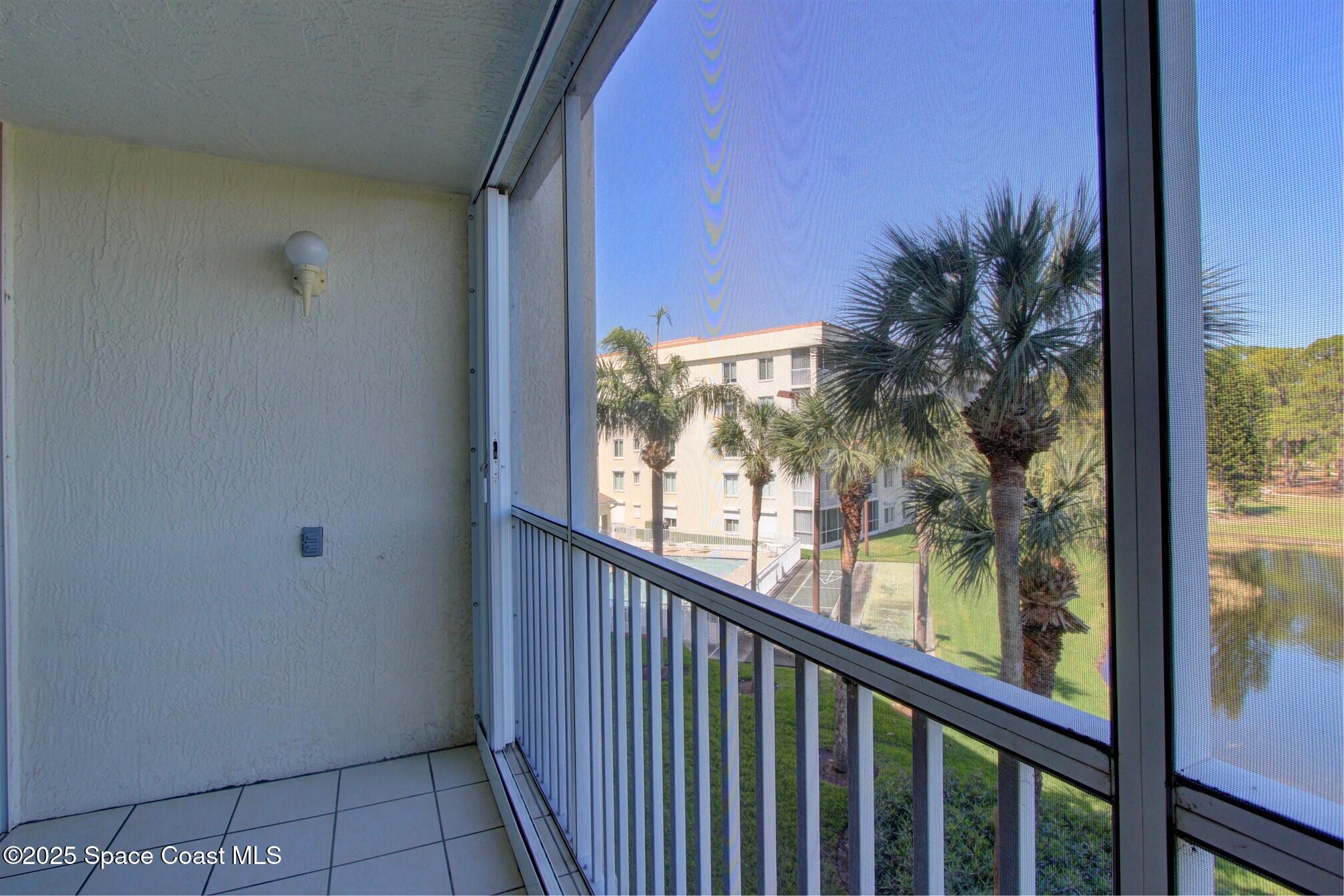 1420 Huntington Lane, Unit 2304 Rockledge, FL 32955 - Photo 14 of 34 a view of a balcony with a tree