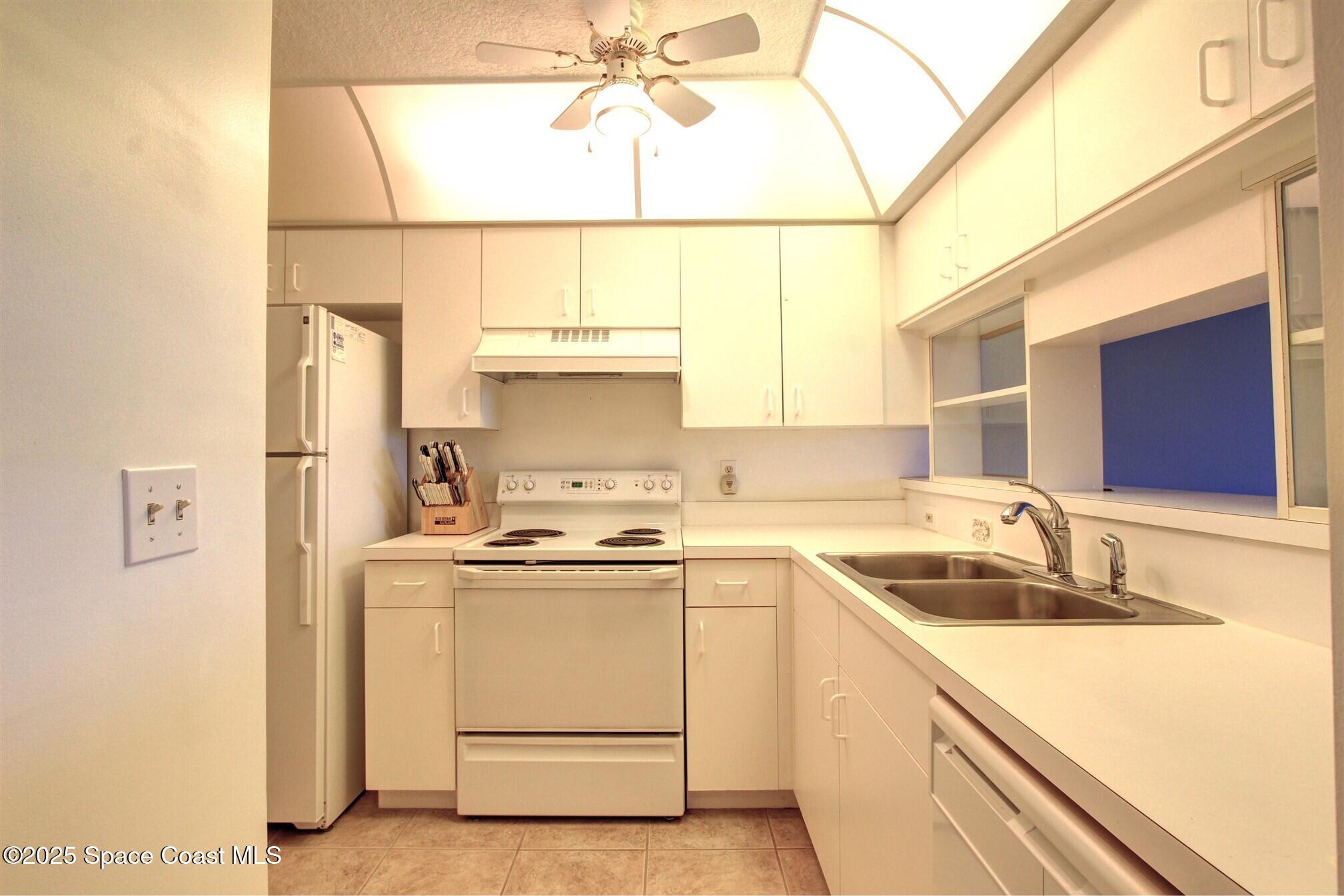 1420 Huntington Lane, Unit 2304 Rockledge, FL 32955 - Photo 19 of 34 a kitchen with a sink stove and refrigerator