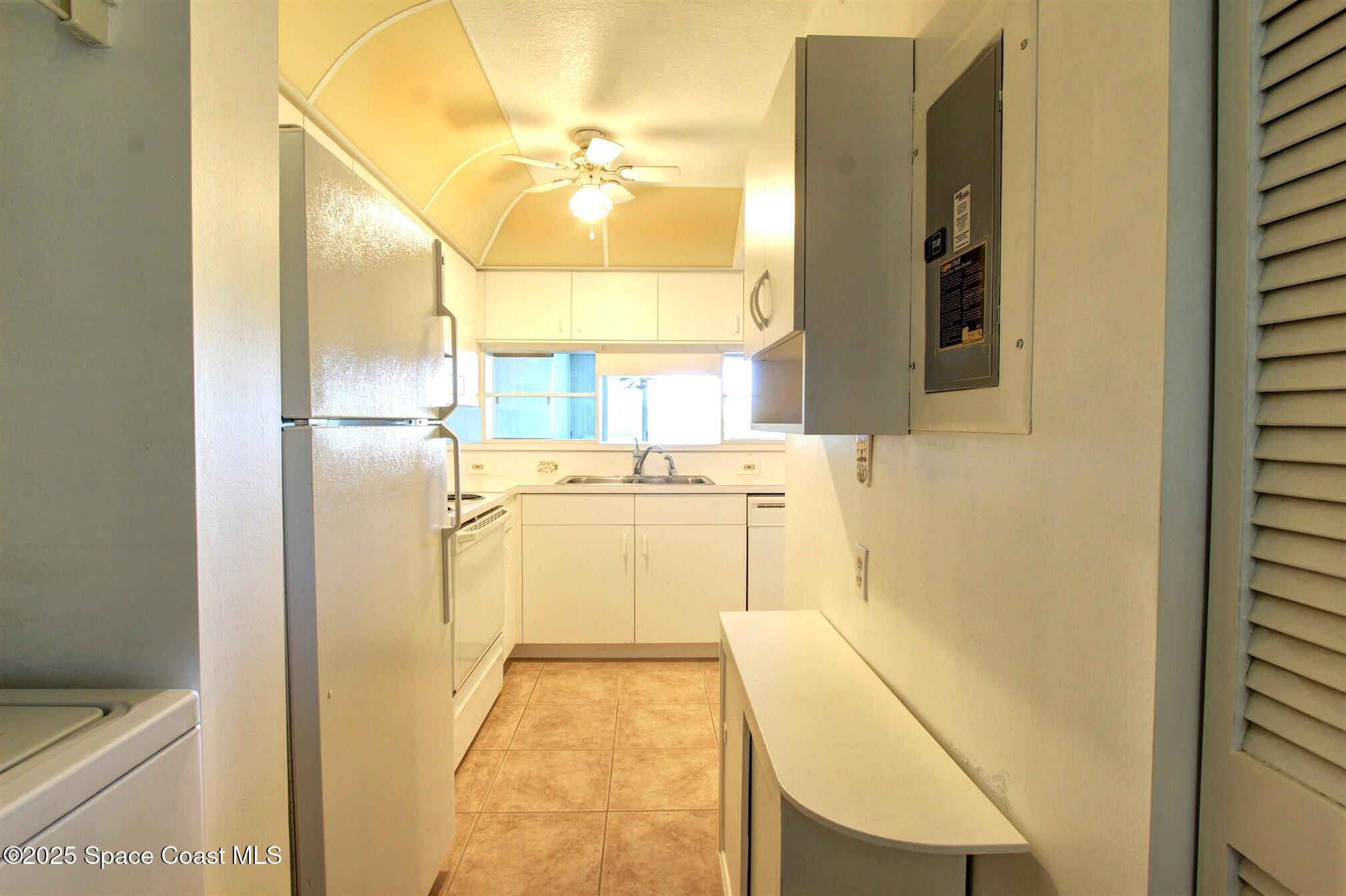 1420 Huntington Lane, Unit 2304 Rockledge, FL 32955 - Photo 21 of 34 a bathroom with a sink a mirror and a shower