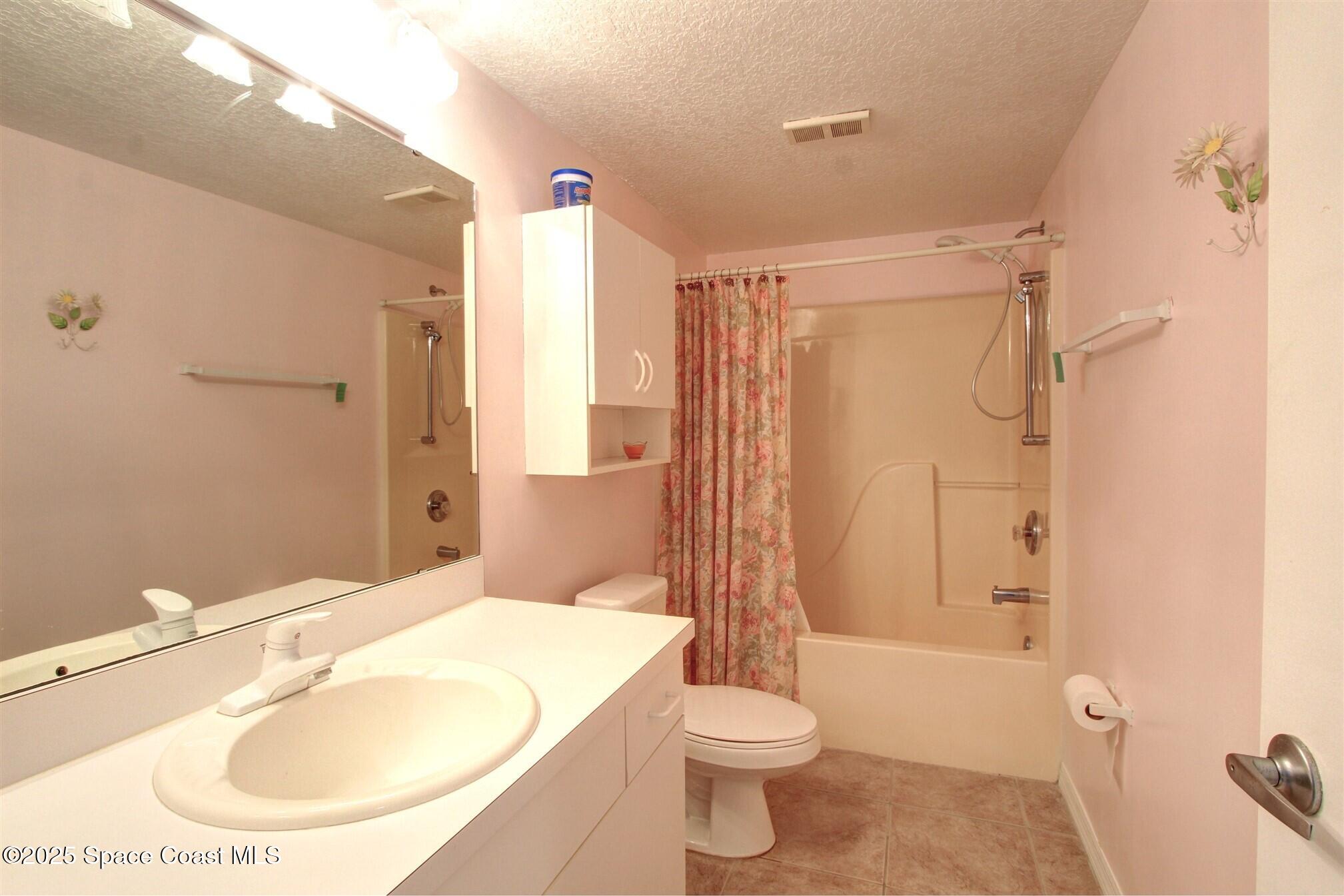 1420 Huntington Lane, Unit 2304 Rockledge, FL 32955 - Photo 26 of 34 a bathroom with a sink toilet and shower