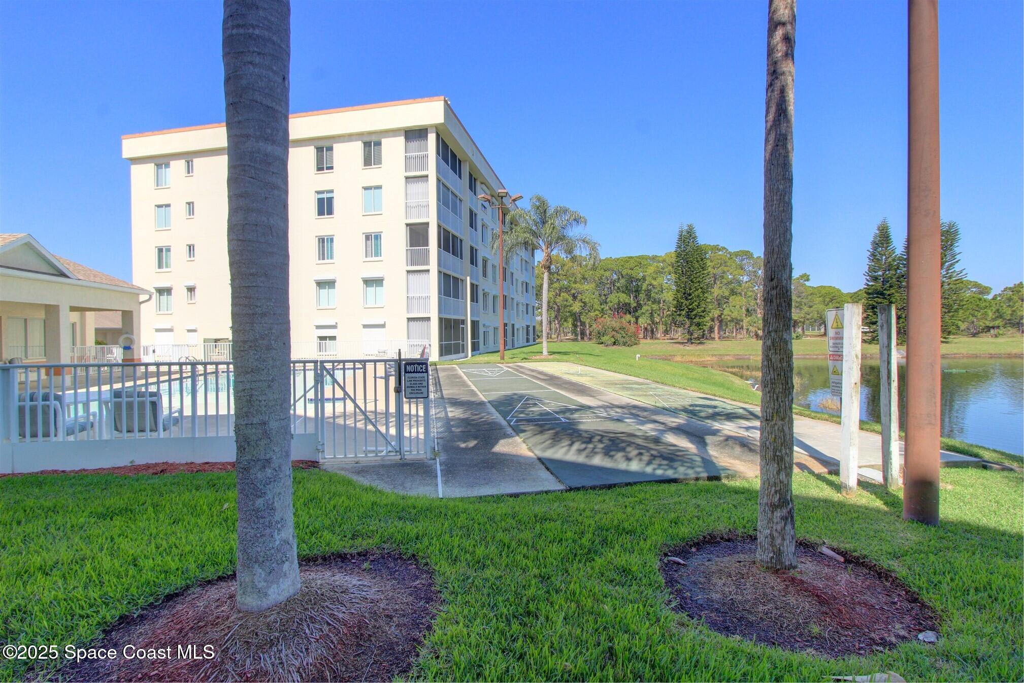 1420 Huntington Lane, Unit 2304 Rockledge, FL 32955 - Photo 5 of 34 a front view of a building with a yard
