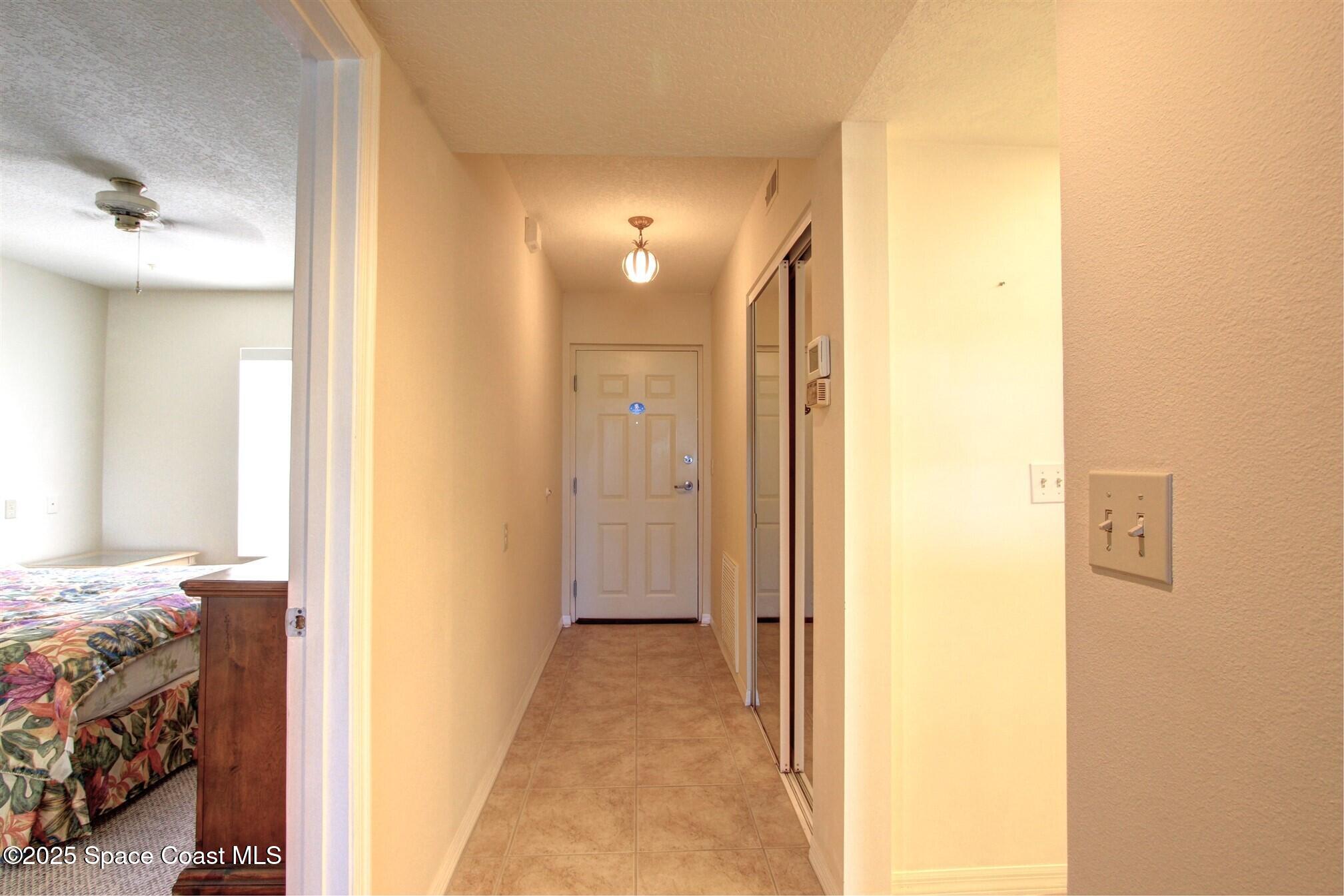 1420 Huntington Lane, Unit 2304 Rockledge, FL 32955 - Photo 10 of 34 a view of a bedroom from a hallway