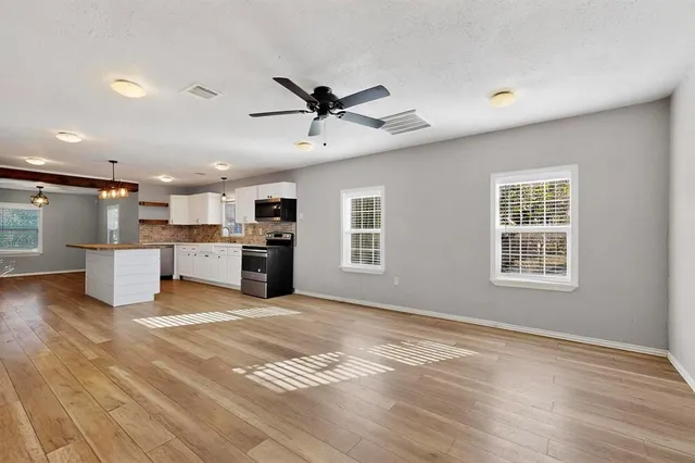 a kitchen with granite countertop a stove and cabinets