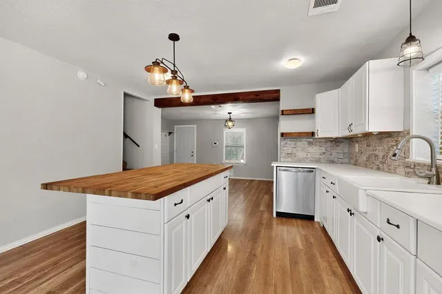 a kitchen with a sink stove and cabinets