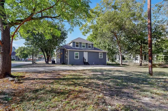 an aerial view of a house with a yard and garden