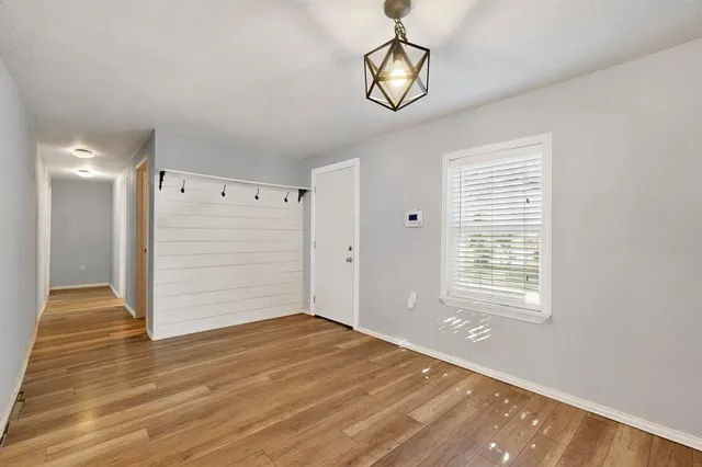 a view of a kitchen with wooden floor and a window