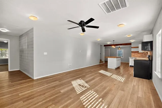 a view of a kitchen with a stove cabinets and wooden floor