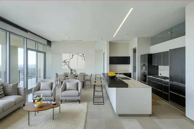 a living room with furniture a large window and a flat screen tv