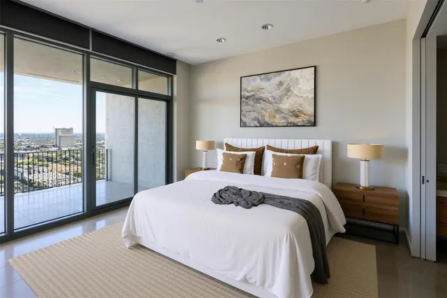 a bedroom with a large bed and a large window