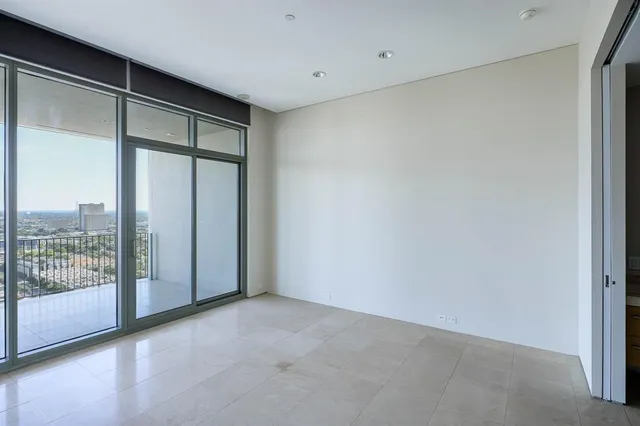 a view of an empty room with glass door