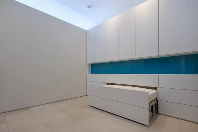 a bathroom with a sink vanity and mirror