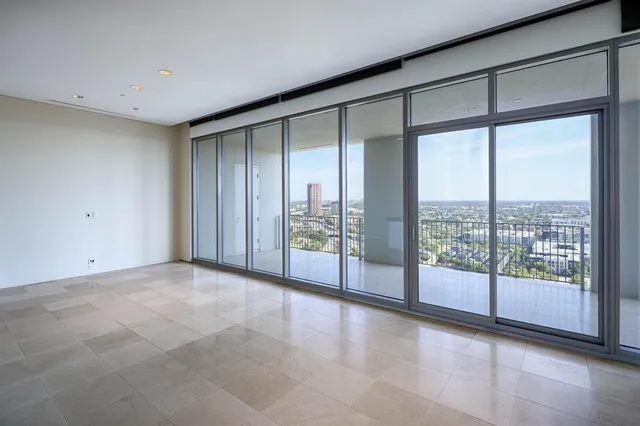 a view of an empty room with windows and city view