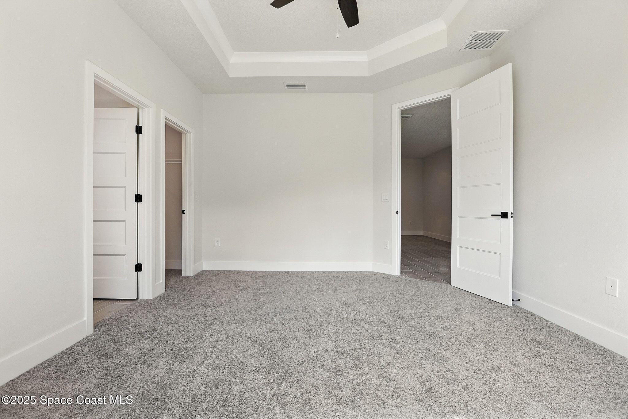 475 Flagler Road Southeast Palm Bay, FL 32909 - Photo 15 of 30 an empty room with closet and a ceiling fan