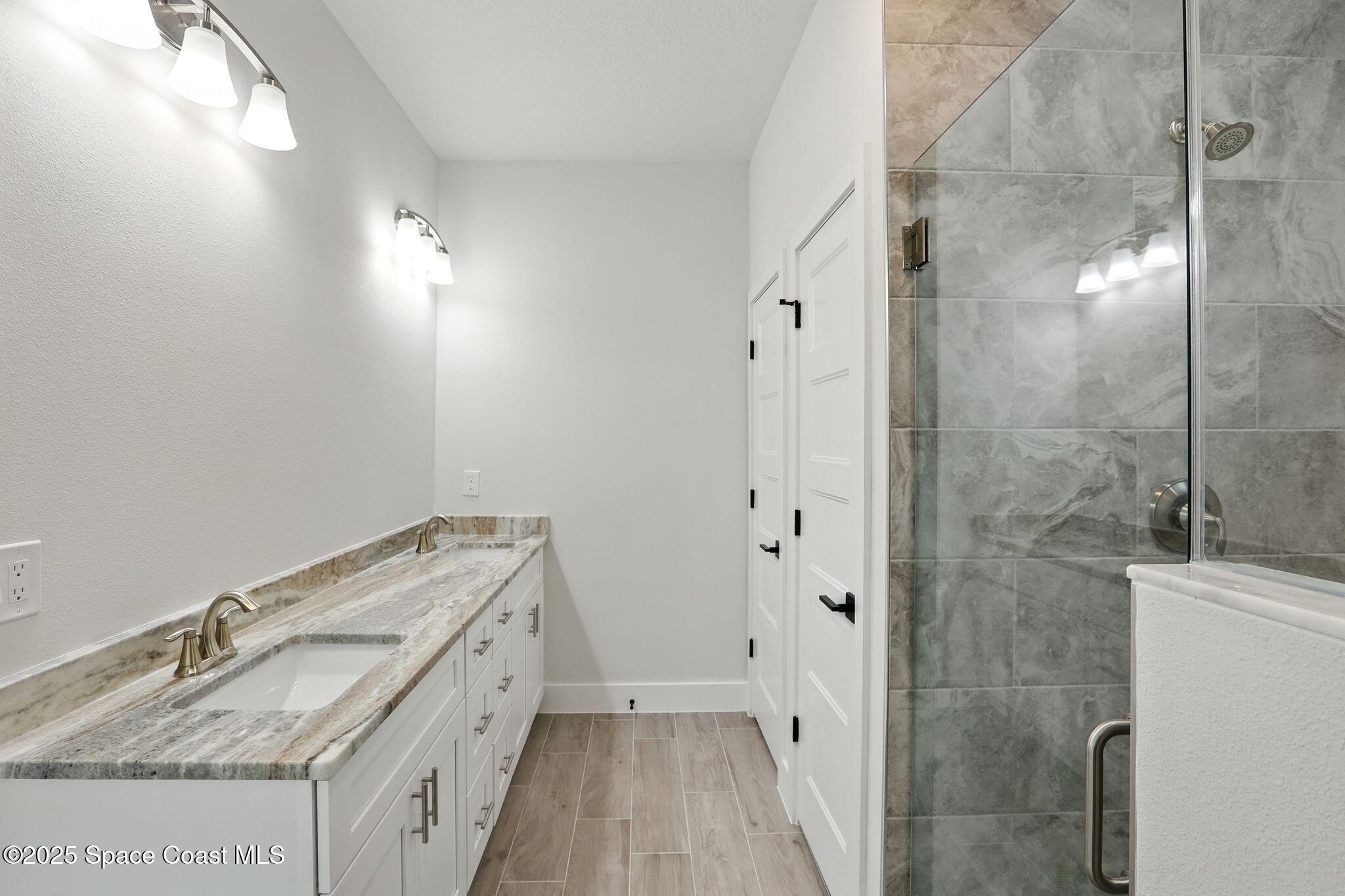 475 Flagler Road Southeast Palm Bay, FL 32909 - Photo 16 of 30 a bathroom with a granite countertop sink a mirror and shower