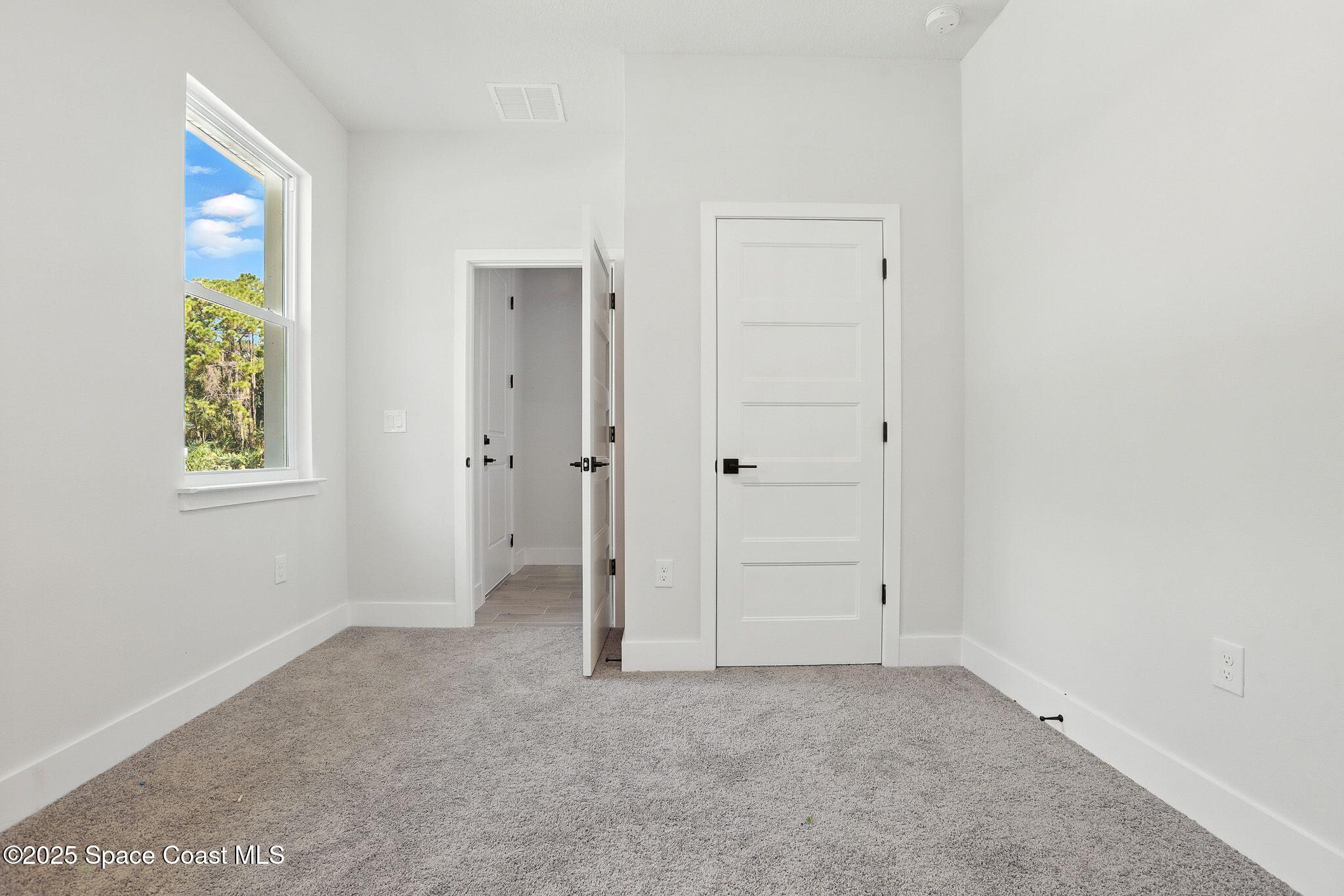 475 Flagler Road Southeast Palm Bay, FL 32909 - Photo 22 of 30 an empty room with windows and closet
