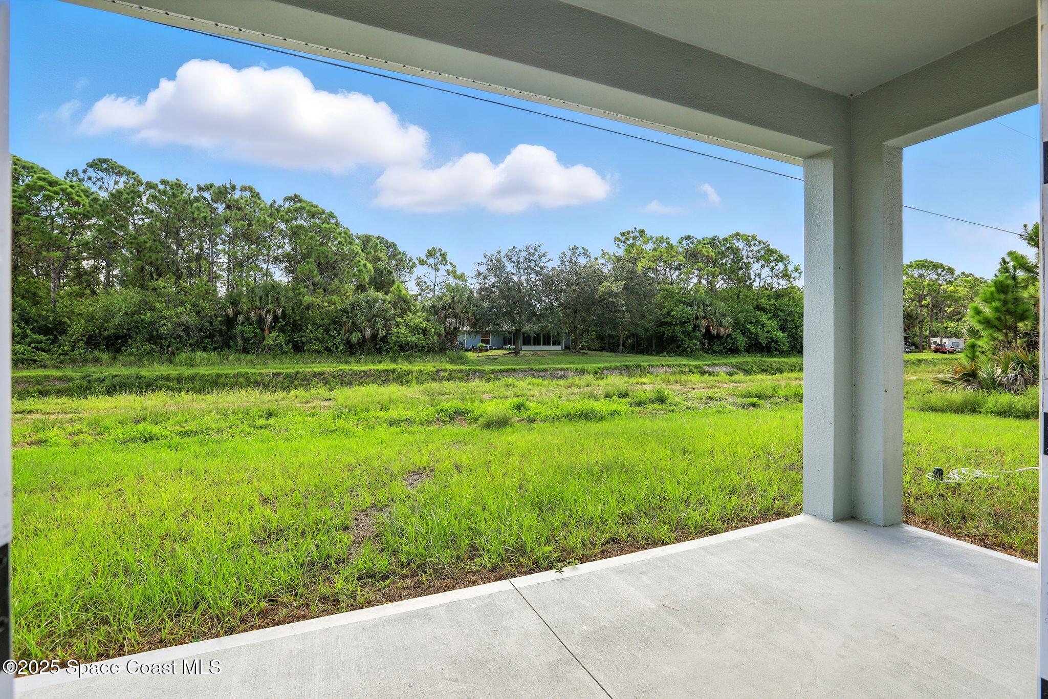 475 Flagler Road Southeast Palm Bay, FL 32909 - Photo 30 of 30 a view of a yard with a tree in front of it