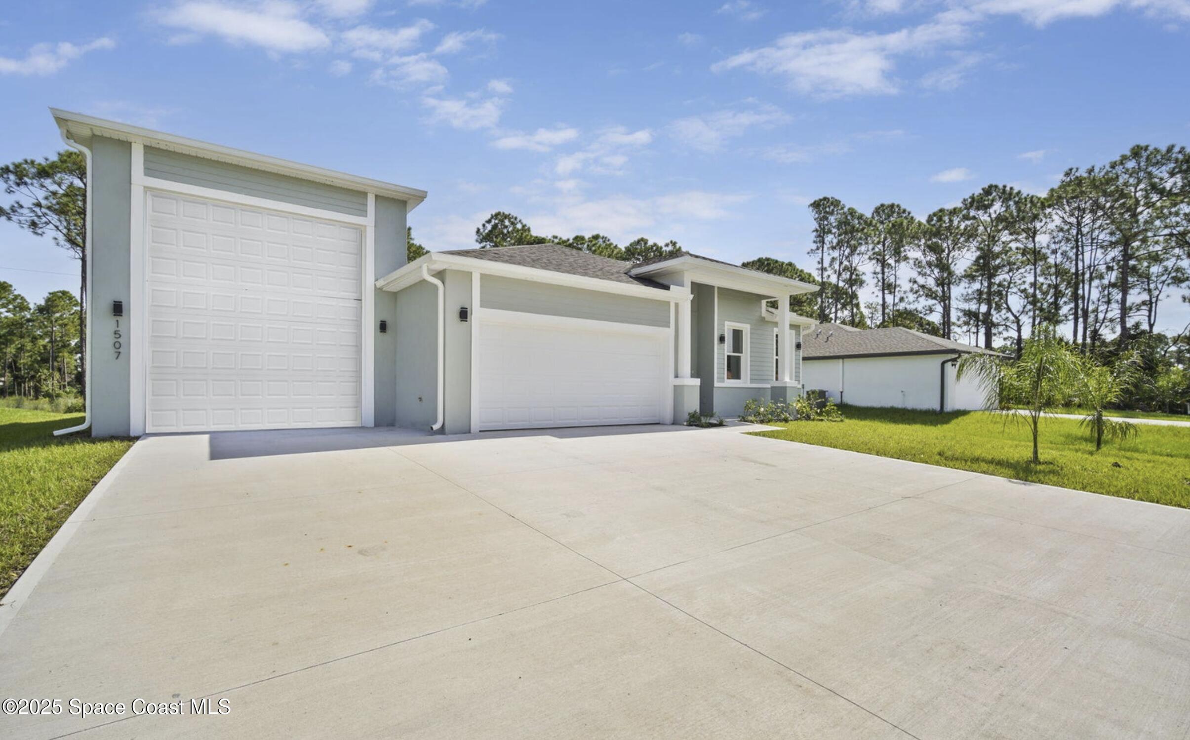 475 Flagler Road Southeast Palm Bay, FL 32909 - Photo 3 of 30 a view of a house with a yard and large tree