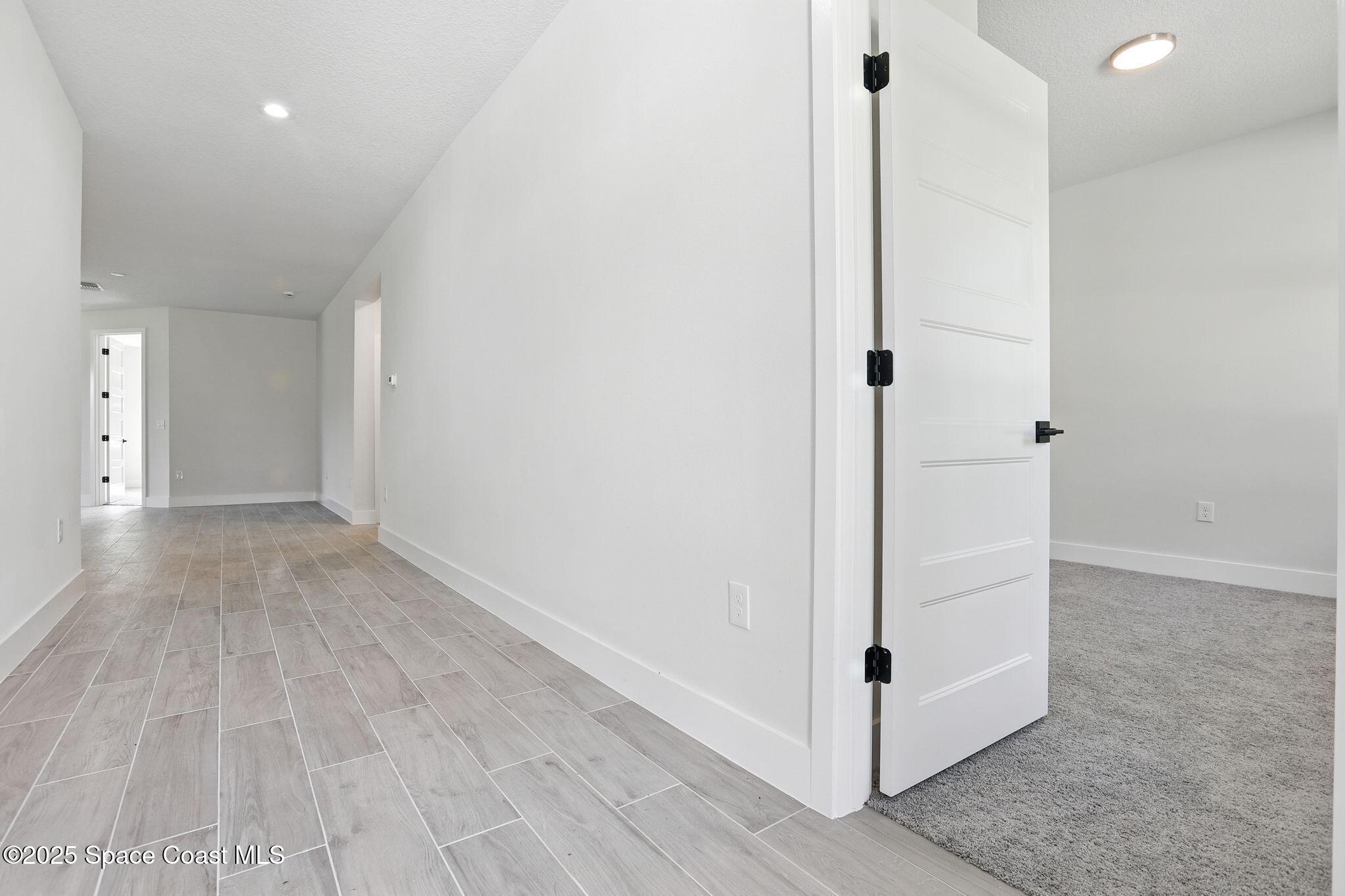 475 Flagler Road Southeast Palm Bay, FL 32909 - Photo 6 of 30 a view of a hallway with wooden floor