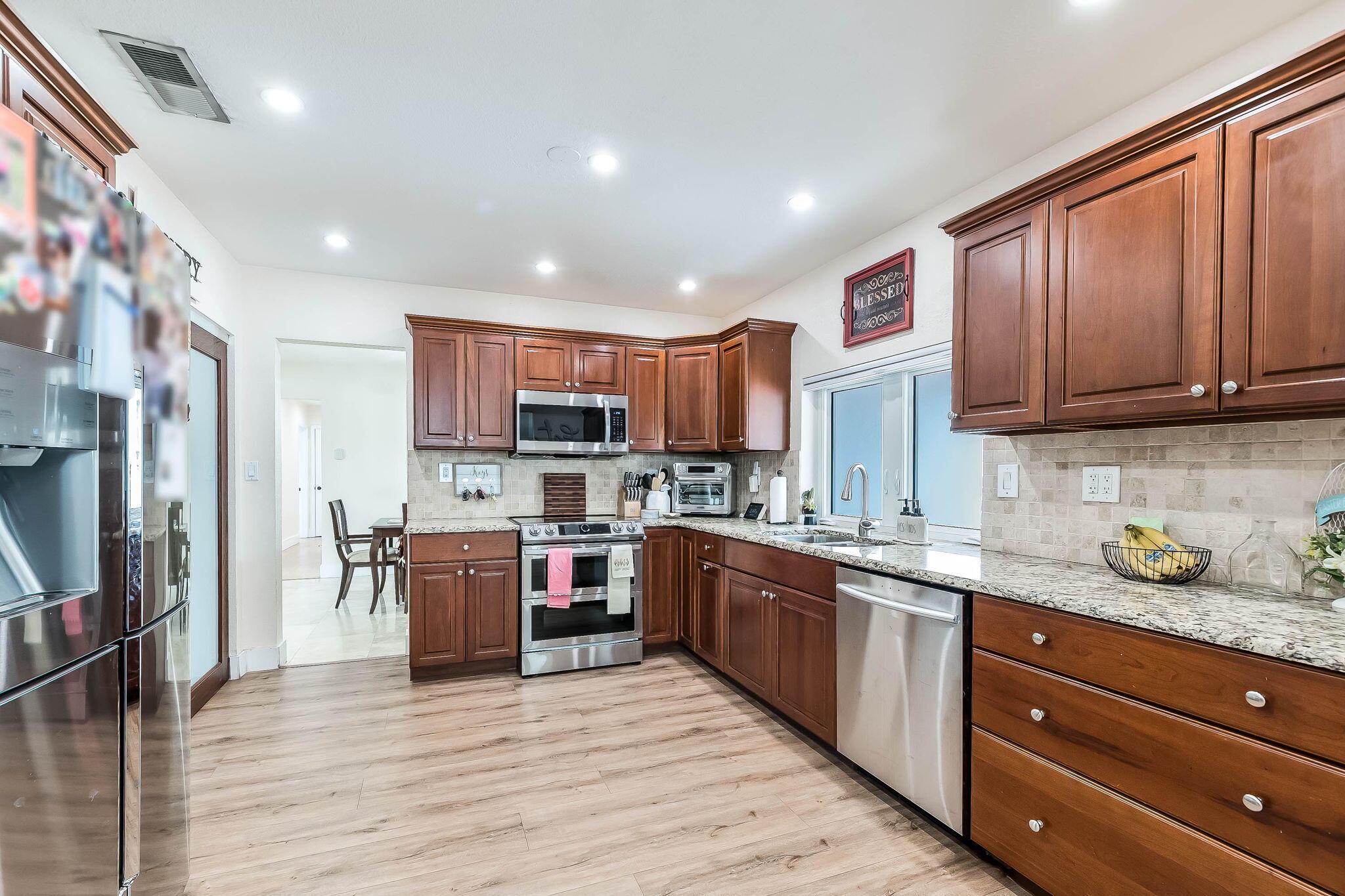 6231 Southwest 94th Avenue Miami, FL 33173 - Photo 13 of 47 a kitchen with stainless steel appliances granite countertop a refrigerator stove top oven and sink