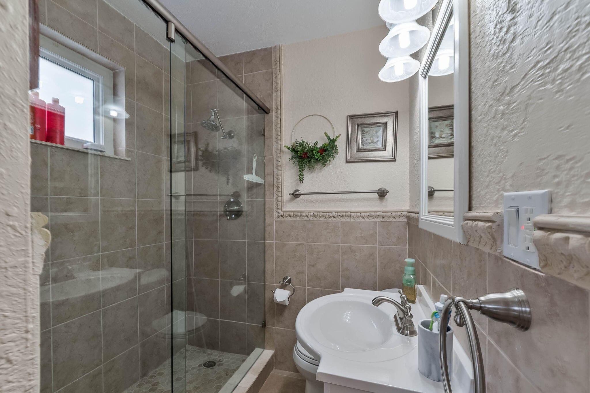 6231 Southwest 94th Avenue Miami, FL 33173 - Photo 19 of 47 a bathroom with a sink a mirror and a shower