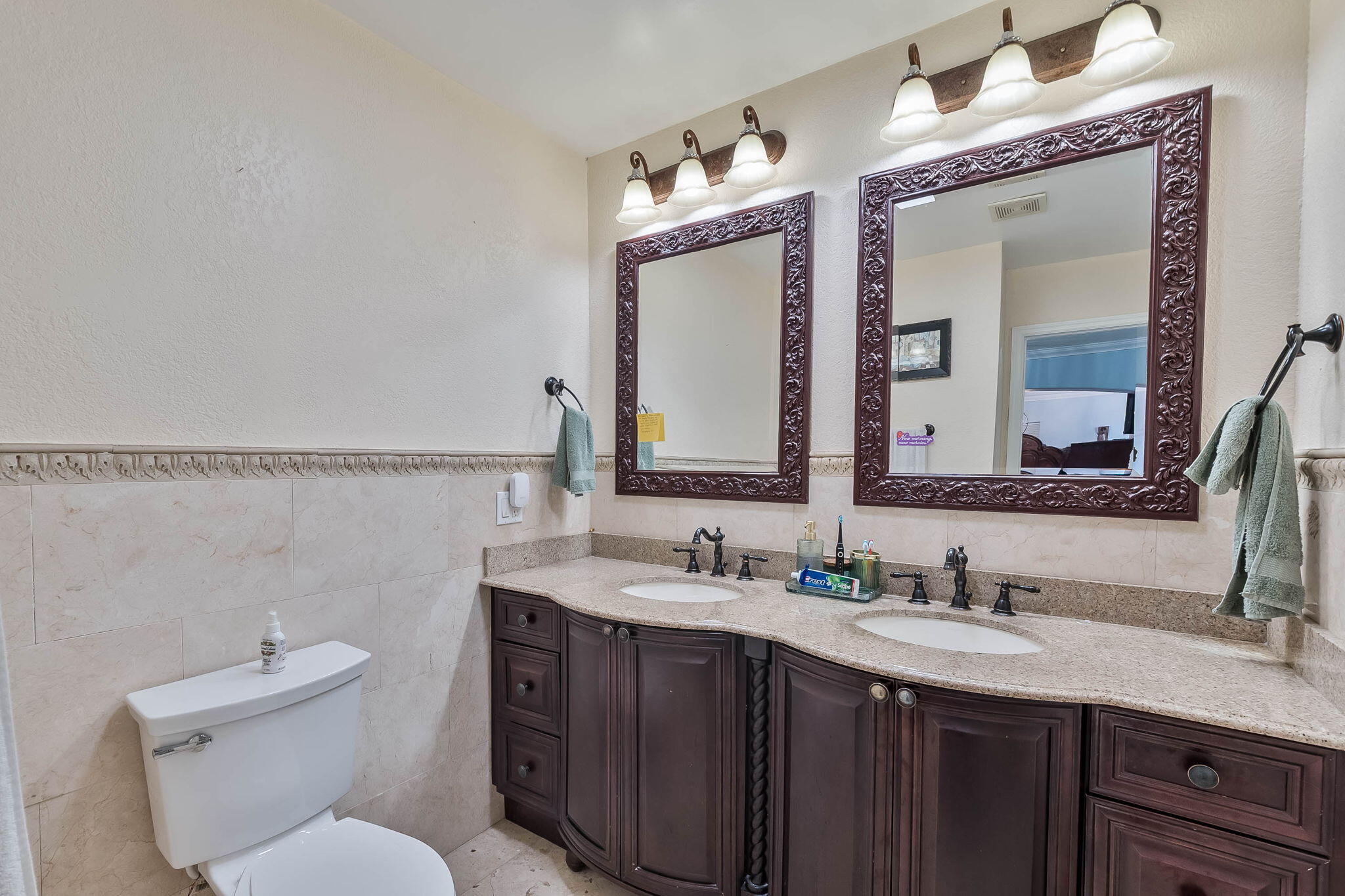 6231 Southwest 94th Avenue Miami, FL 33173 - Photo 24 of 47 a bathroom with a granite countertop toilet sink and mirror