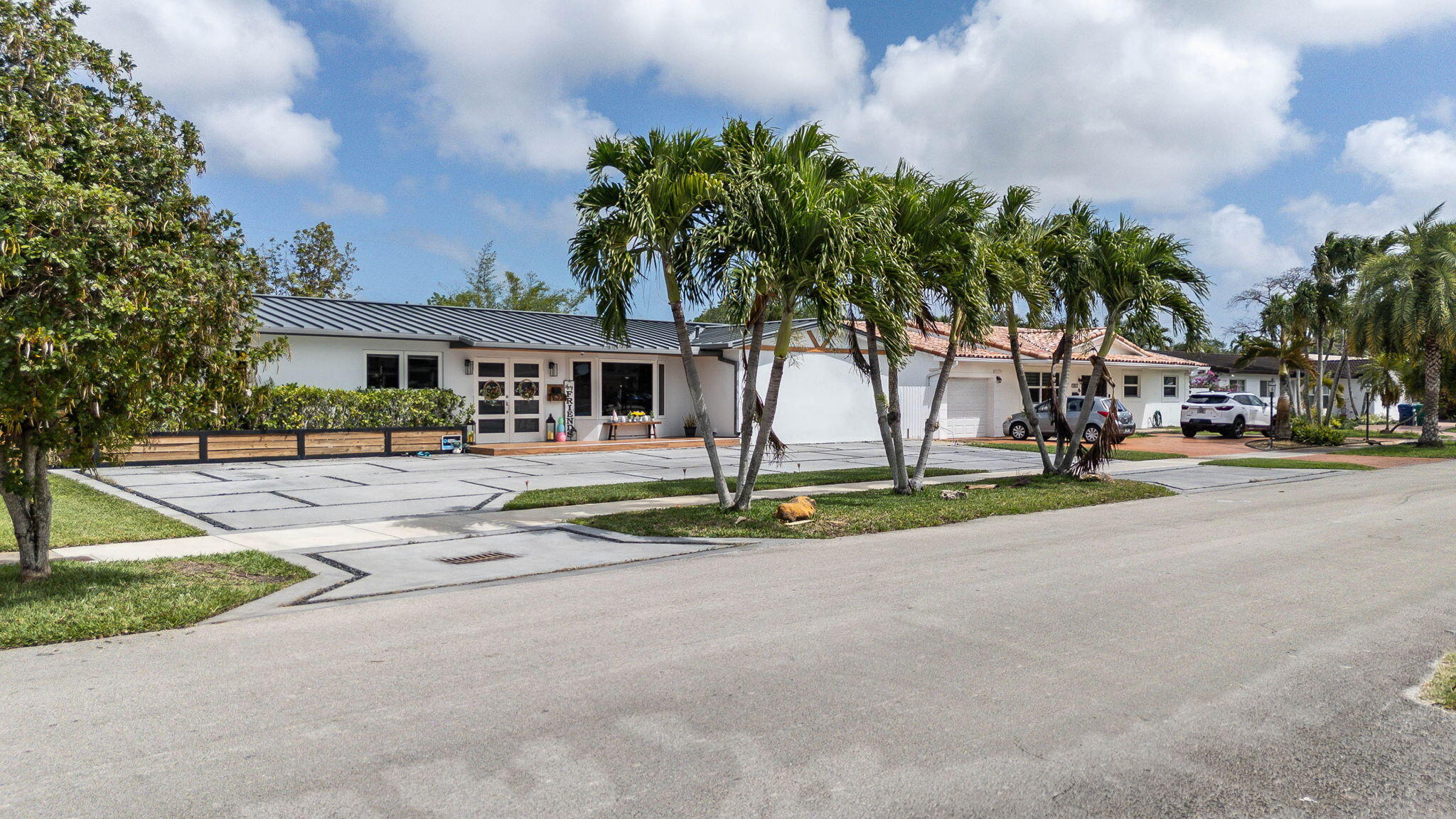 6231 Southwest 94th Avenue Miami, FL 33173 - Photo 4 of 47 a front view of a house with a garden and trees