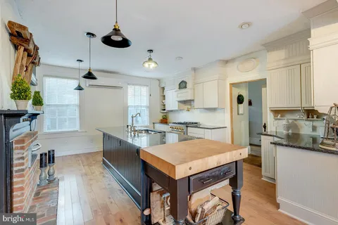 a kitchen with stainless steel appliances granite countertop a refrigerator and a stove top oven