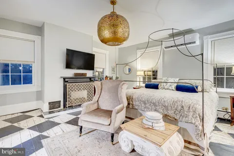 a living room with furniture a flat screen tv and kitchen view