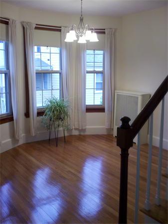 1-3 Rockingham Place Cambridge, MA 02139 - Photo 17 of 23 a view of an empty room with wooden floor and a window